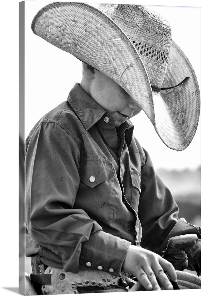 Young cowboy looking pensive in the saddle