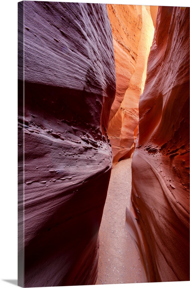 A photograph through a narrow canyon corridor.