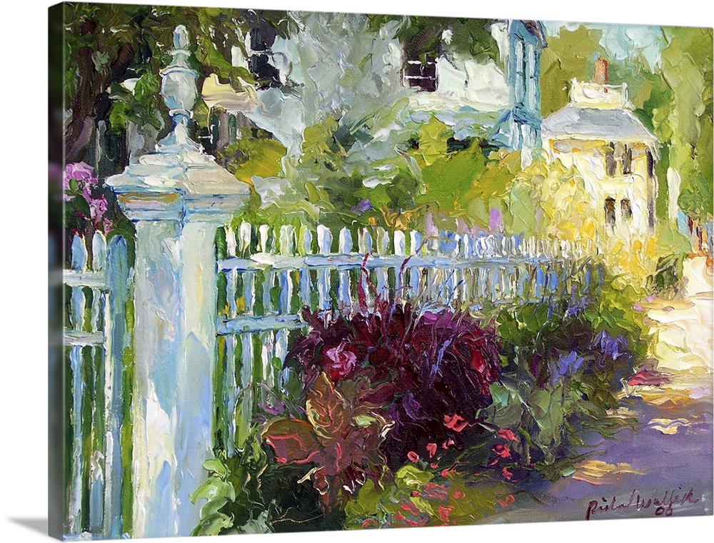 White picket fence lined with flowers.