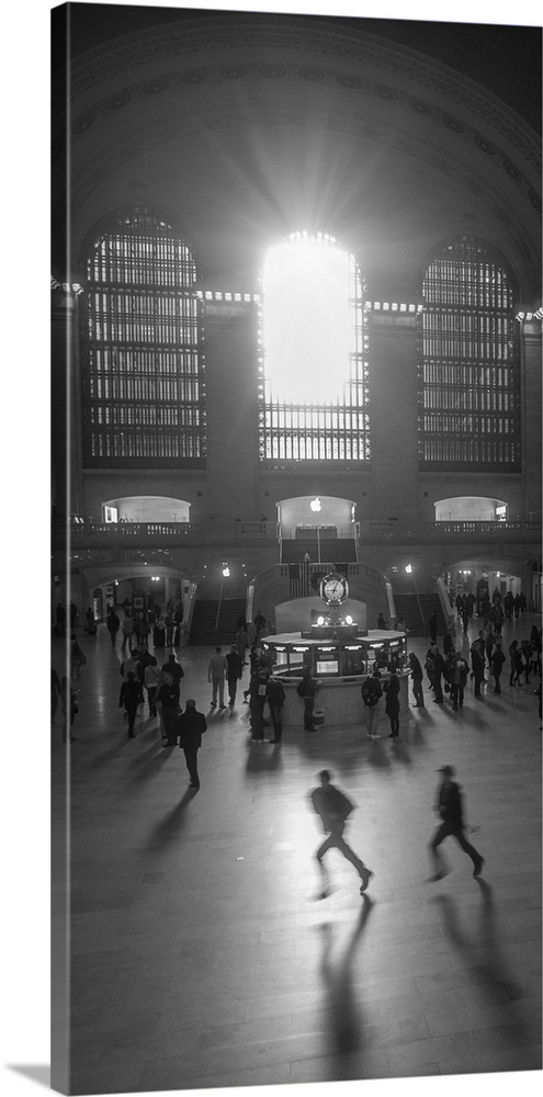An artistic black and white photograph of silhouetted people inside Grand Central Station.