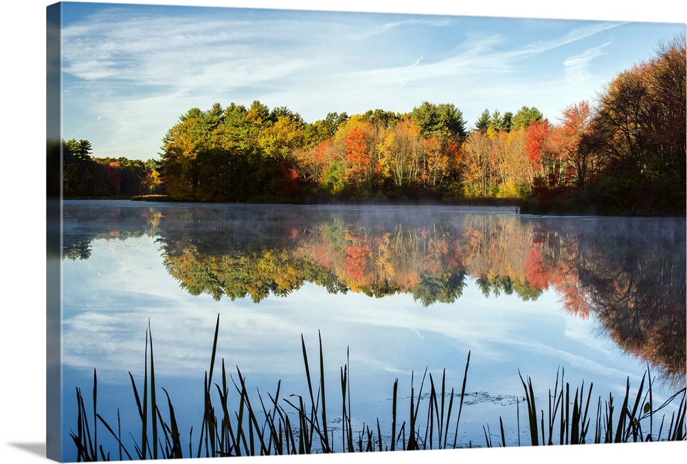 Landscape photograph of Grist Millpond, Massachusetts, with Fall trees reflecting on to the water.