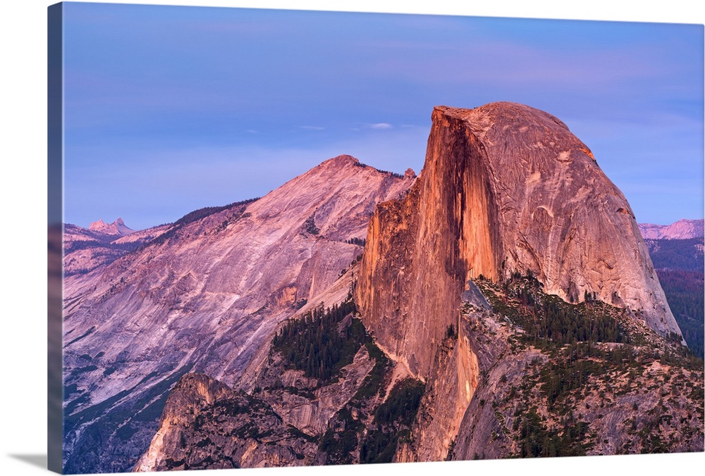 Half Dome in Yosemite bathed in pink light from the sunset.