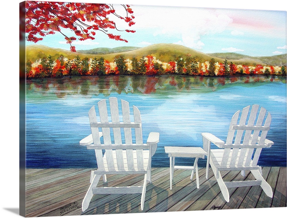White chairs on a deck overlooking a lake and the autumn foliage.