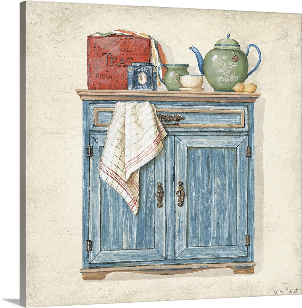 Sideboard cabinet with teapot, box of teas, creamer, teacup and towel.
