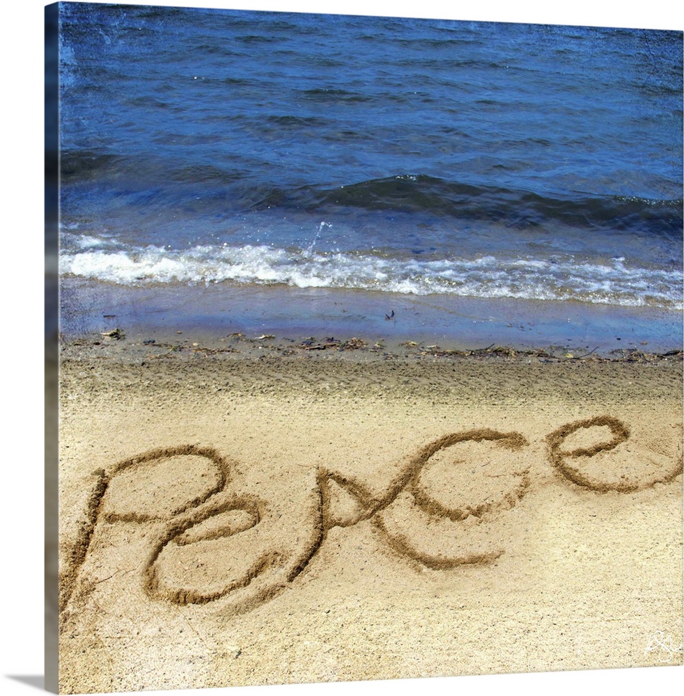 Photograph of a motivational sentiment written in the sand on a beach.
