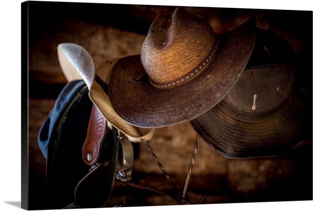 Photograph of western gear including cowboy hats and spurs.
