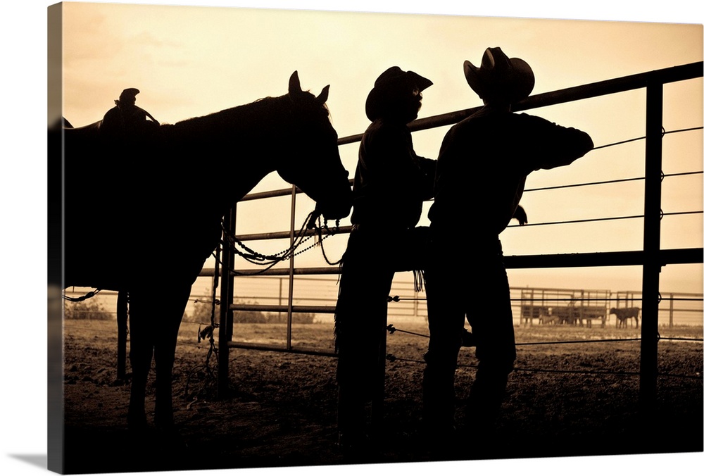 2 cowboys talking at the corral