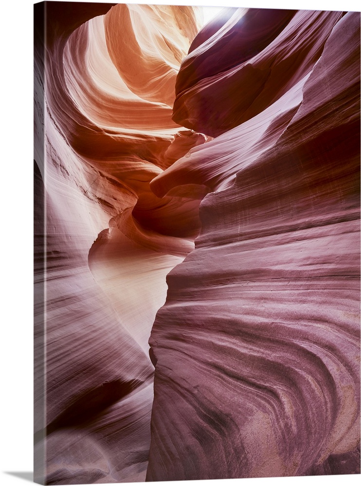 An artistic photograph of reddish purple smooth layered rock formations.