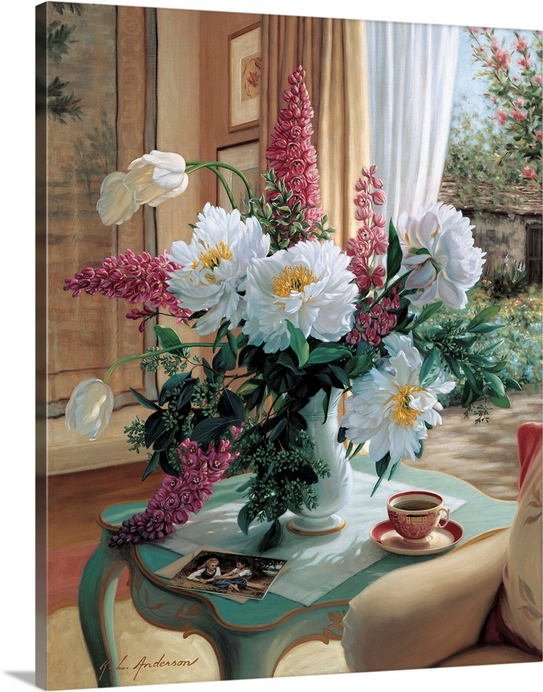 Bouquet of Peonies, French Tulips and delphiniums in a vase on a table with coffee cup by a window.