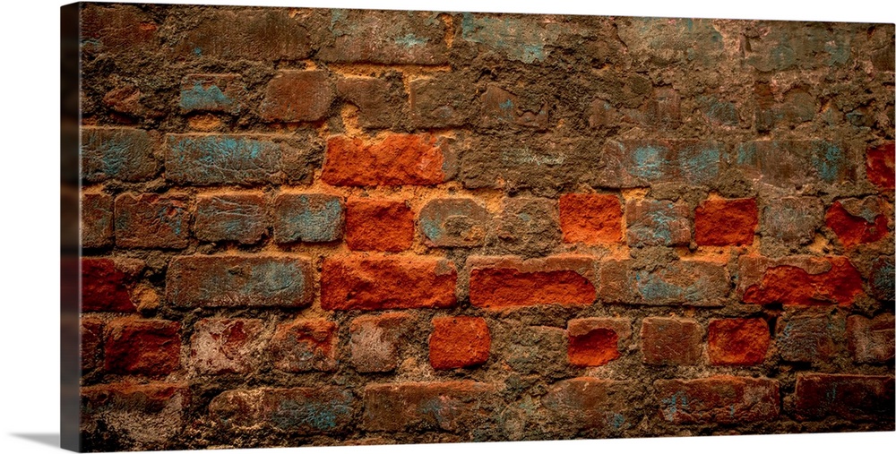 Photograph of a brick wall with some blue paint.