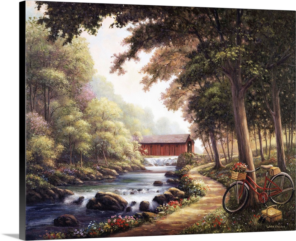 Bicycle path next to a stream with a covered bridge in the background.