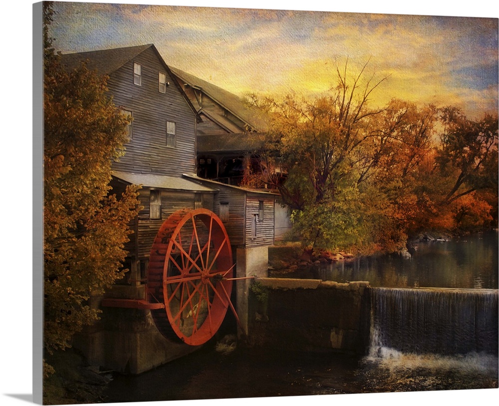 Fine art photo of a water mill at sunset in the fall.