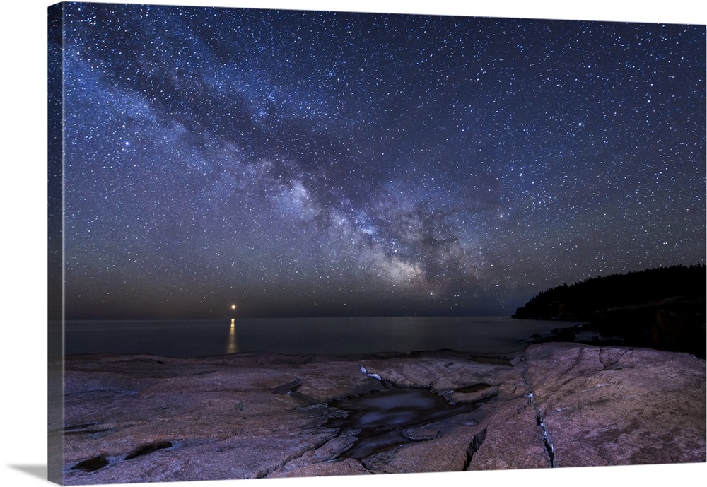 Nighttime photograph of a starscape highlighting Venus over Acadia National Park, Maine.