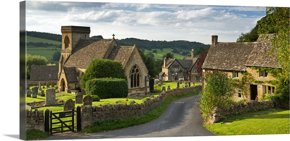 A quaint countryside village with cottages and stone fences.