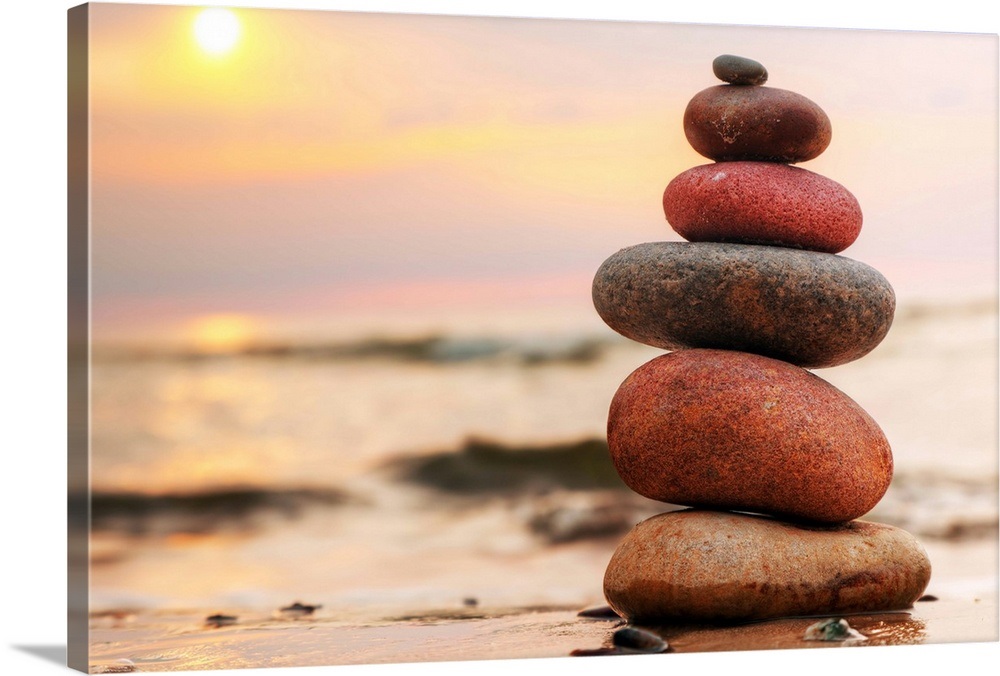 Stacked stones on a beach at sunset Wall Art, Canvas Prints, Framed