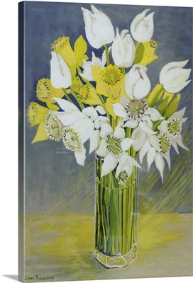 Daffodils and white tulips in an octagonal glass vase