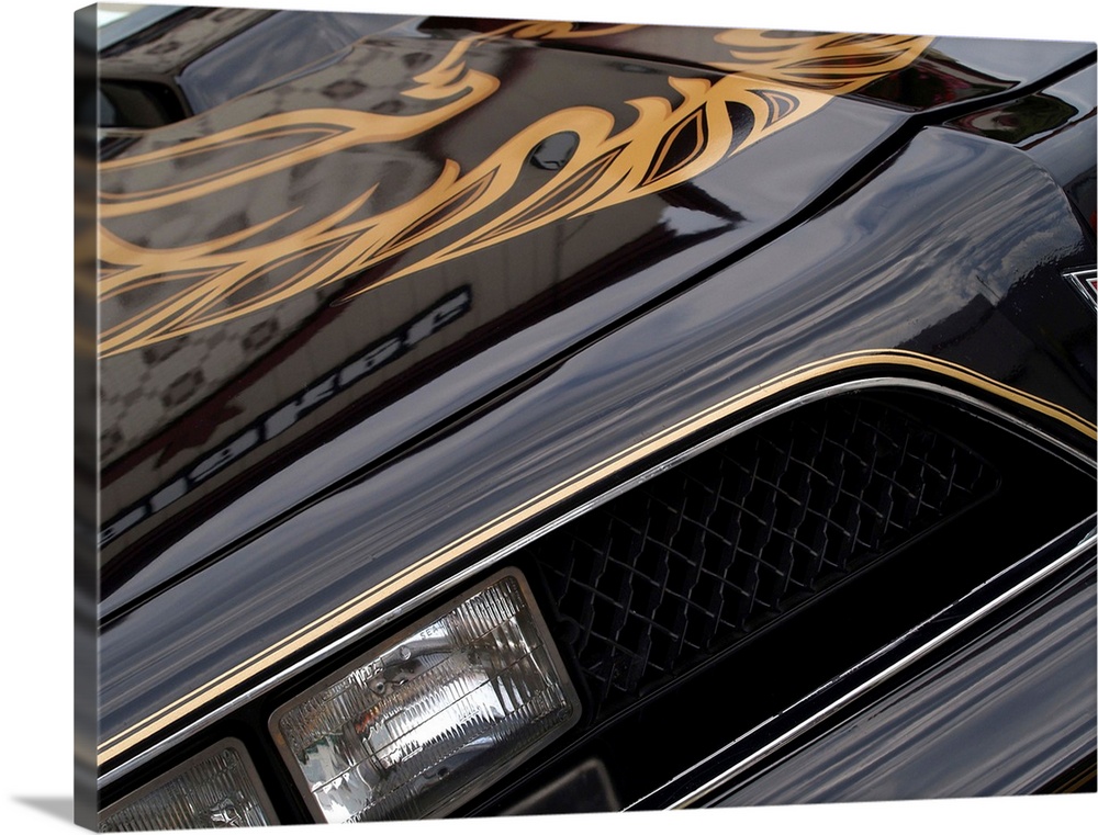 Angled photograph of the front of a black and gold 1978 Pontiac Trans Am.