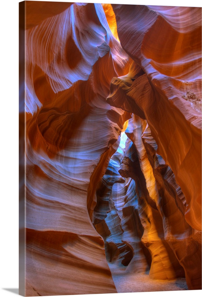 Photograph inside Antelope Canyon with the sun peaking in through the cracks.