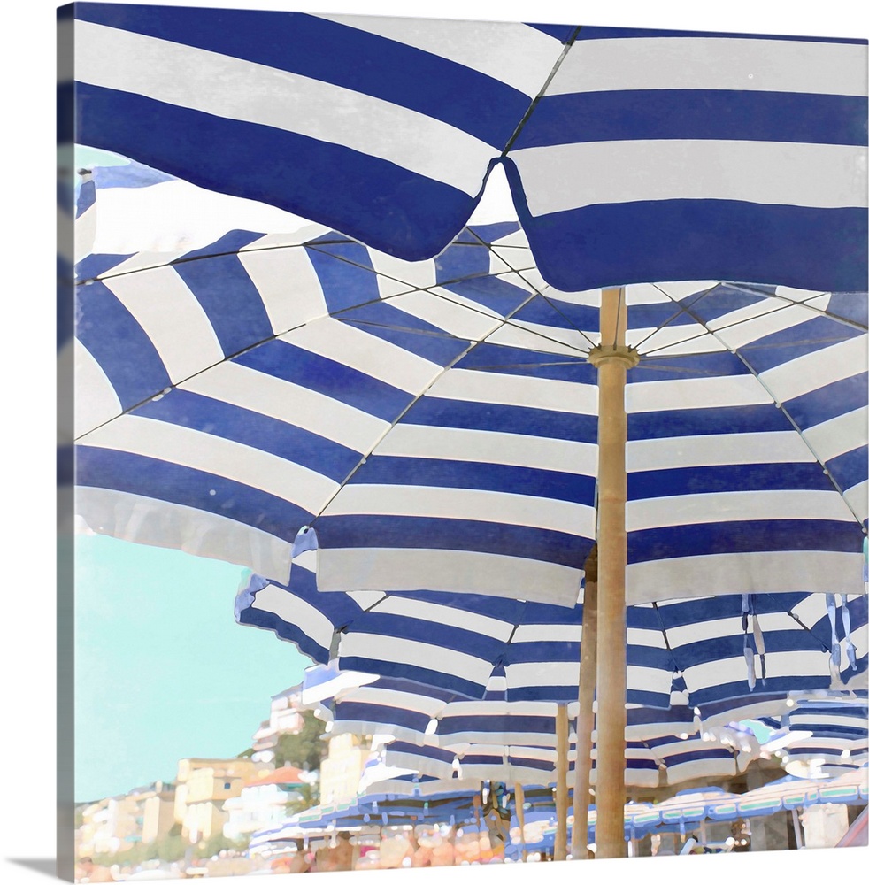 Square decor with blue and white striped beach umbrellas lined up on the beach.