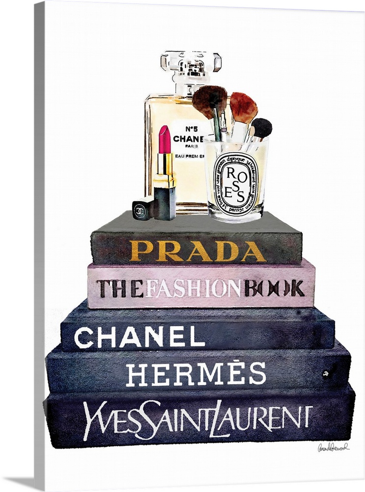 Makeup items sit atop a stack of designer books.