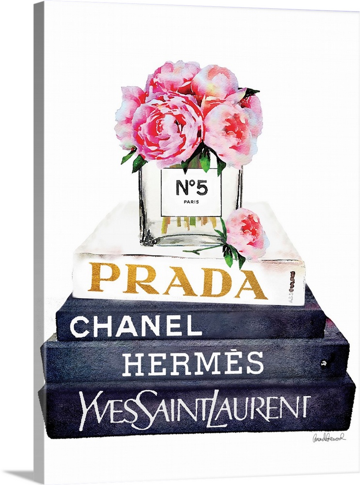 A bouquet of flowers sit atop a stack of designer books.