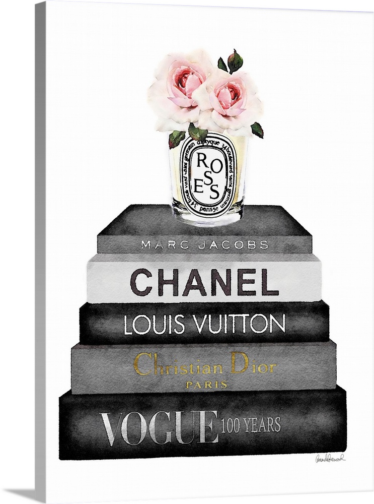 A bouquet of flowers sit atop a stack of designer books.
