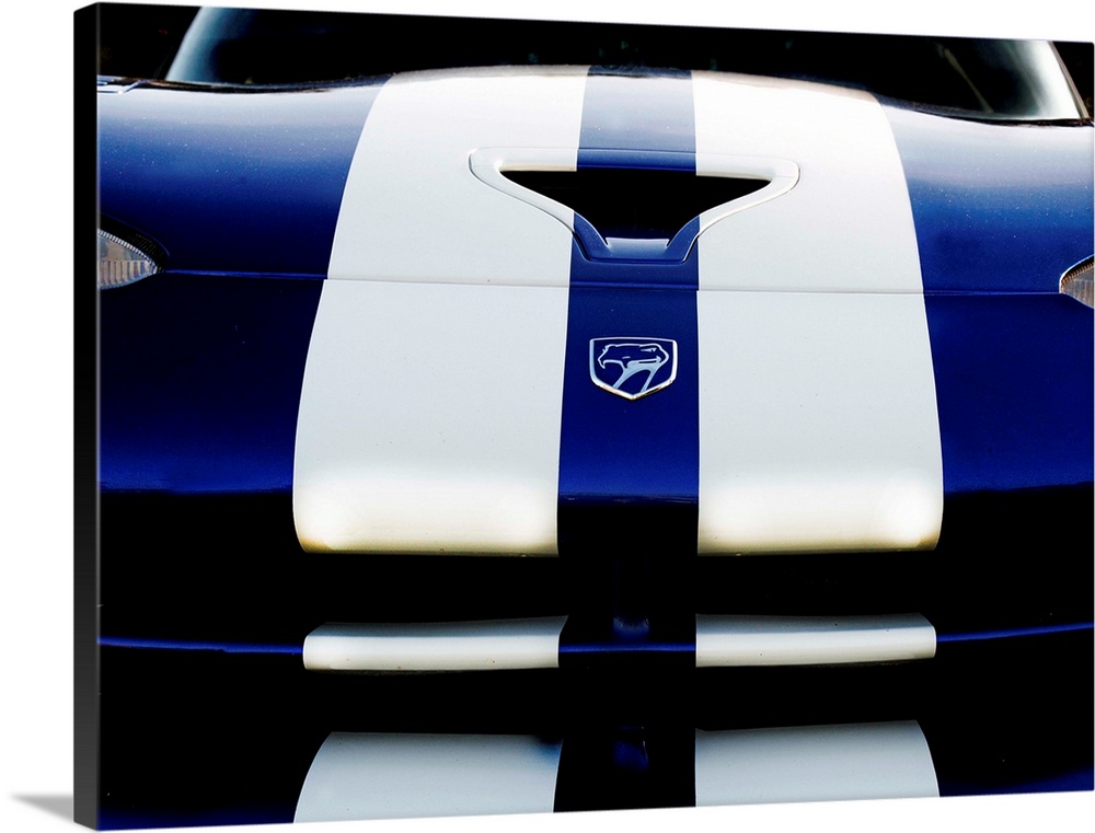 Close-up photograph of the front of a blue Dodge Viper 4 with two white stripes running down it.