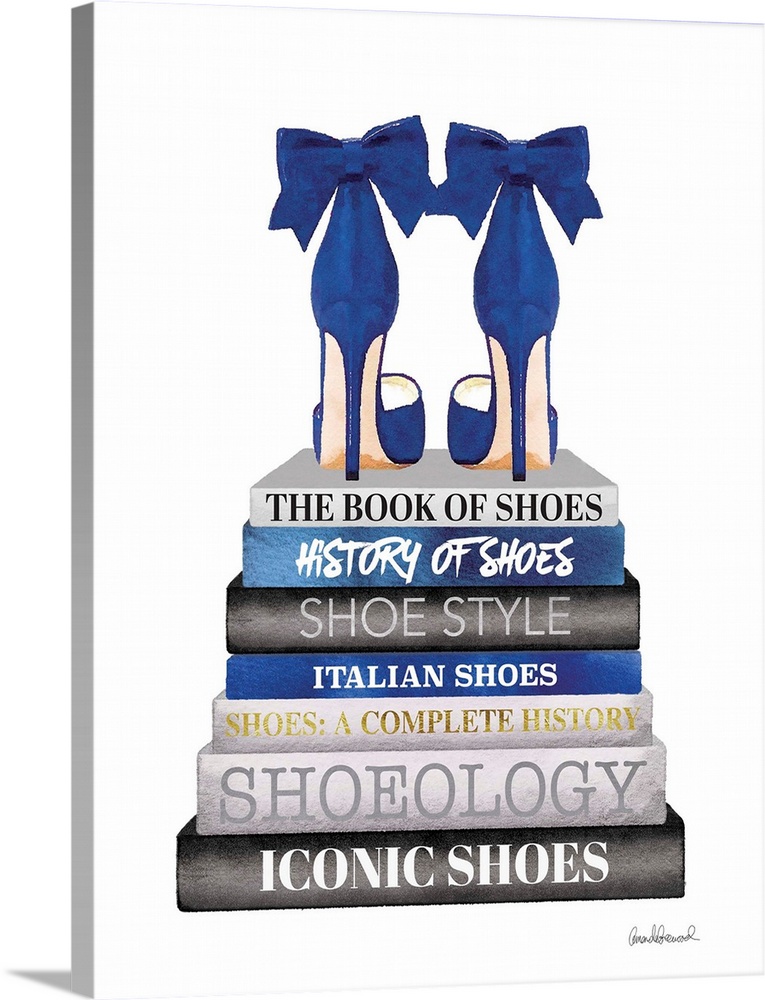 Shoes sit atop a stack of designer books.