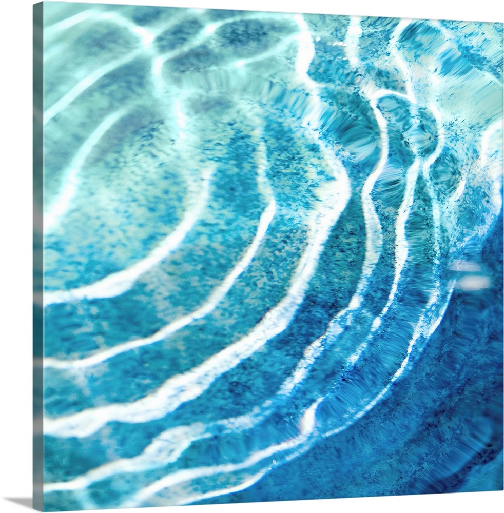 Square photograph of ripples in clear blue water.