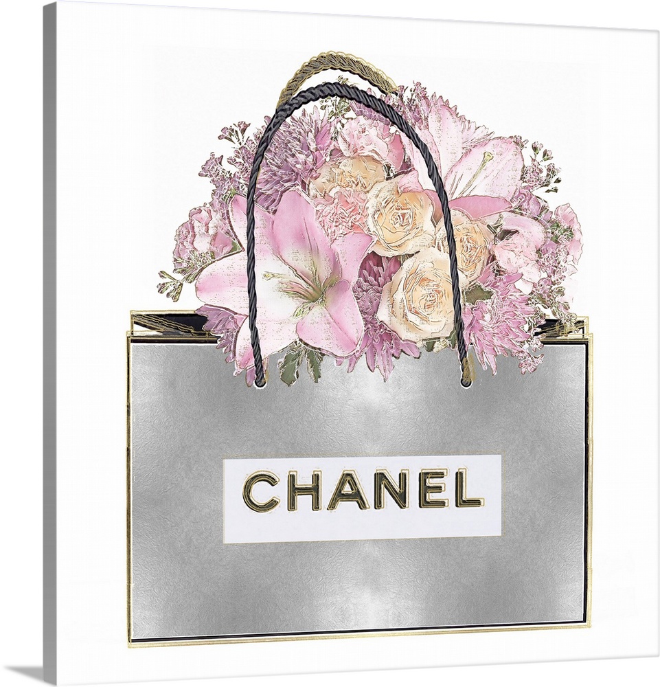 A bouquet of flowers sits atop a shopping bag.