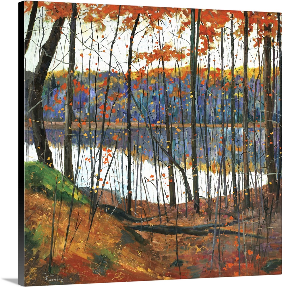 A colorful fall scene of a forest surrounding a lake with the trees reflecting in the water.