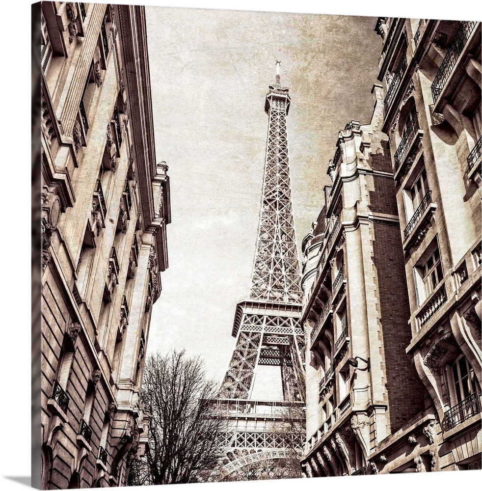 A square photo of the Eiffel Tower from the street in a sepia tone and a textured effect overlay.