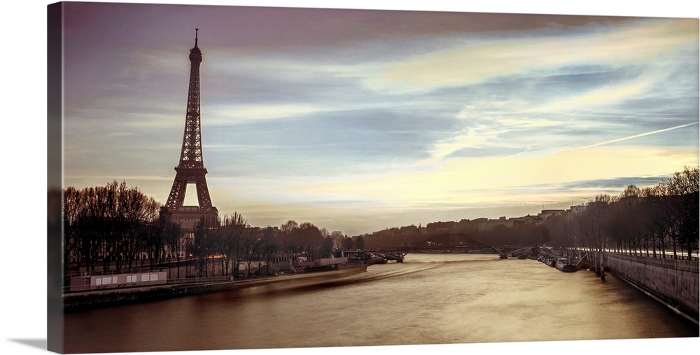 Panoramic image of Paris with the Eiffel tower and Seine River in the evening.