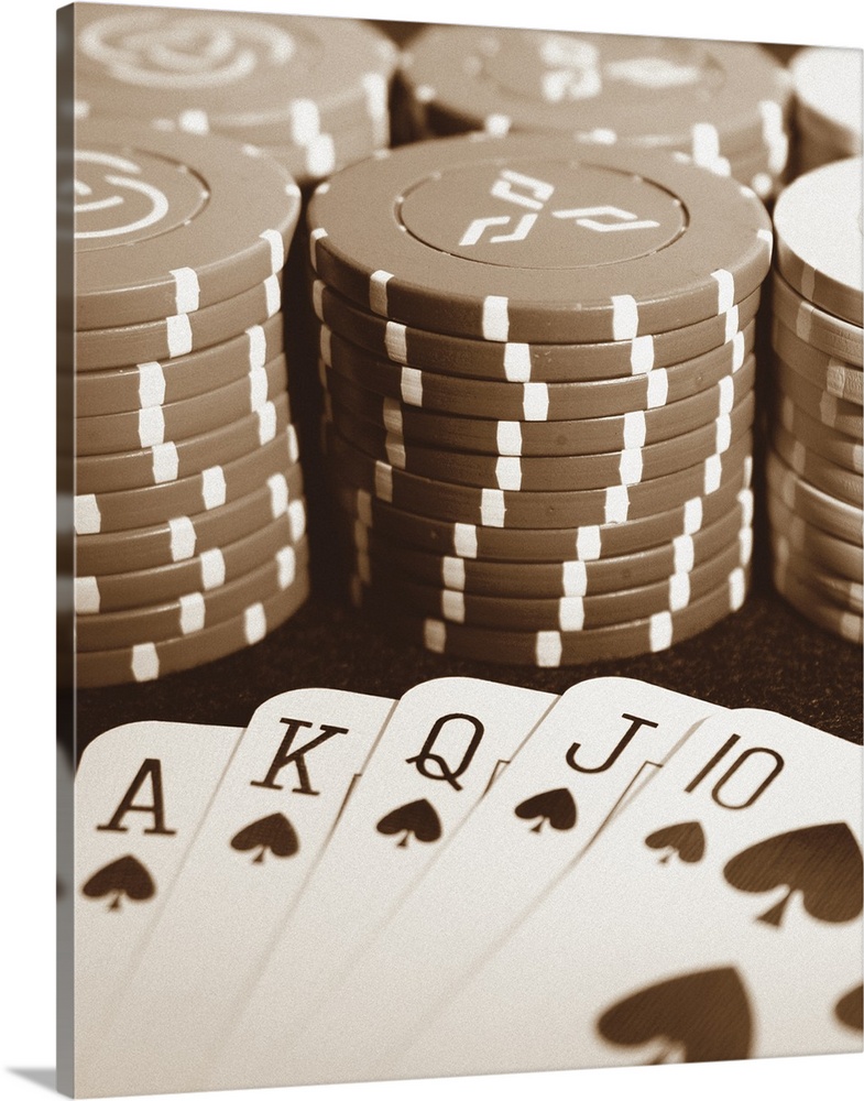 Sepia toned photo of poker chips and cards on a table.