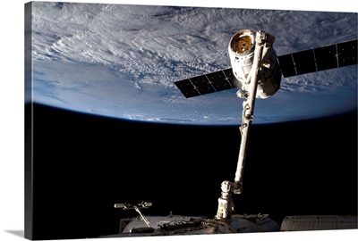 This is how a Dragon looks, snared and tamed by Canadarm2, all quiet just before sunset