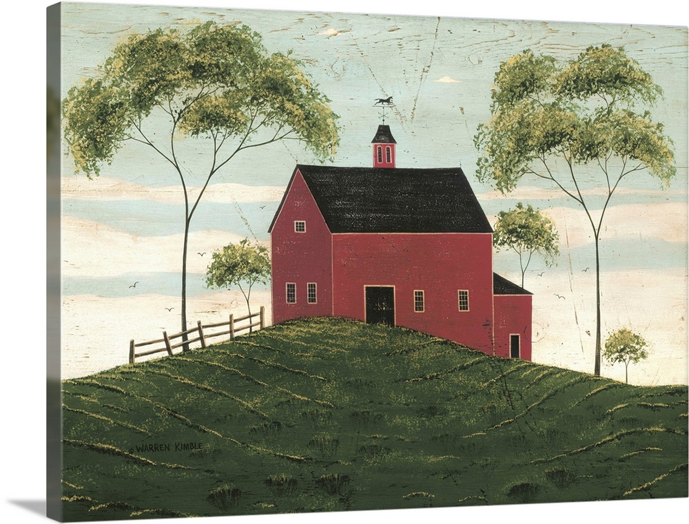 A large barn is painted sitting on a hill and surrounded by two very tall trees and some smaller.