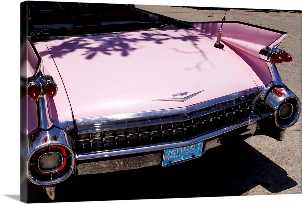Classic 1959 pink Cadillac convertible on road in beautiful Varadero Beach in Valadero Cuba