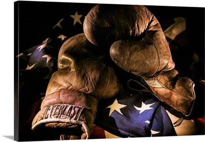 A Pair Of Vintage Boxing Gloves Laying On A Flag Carefully Painted With Light