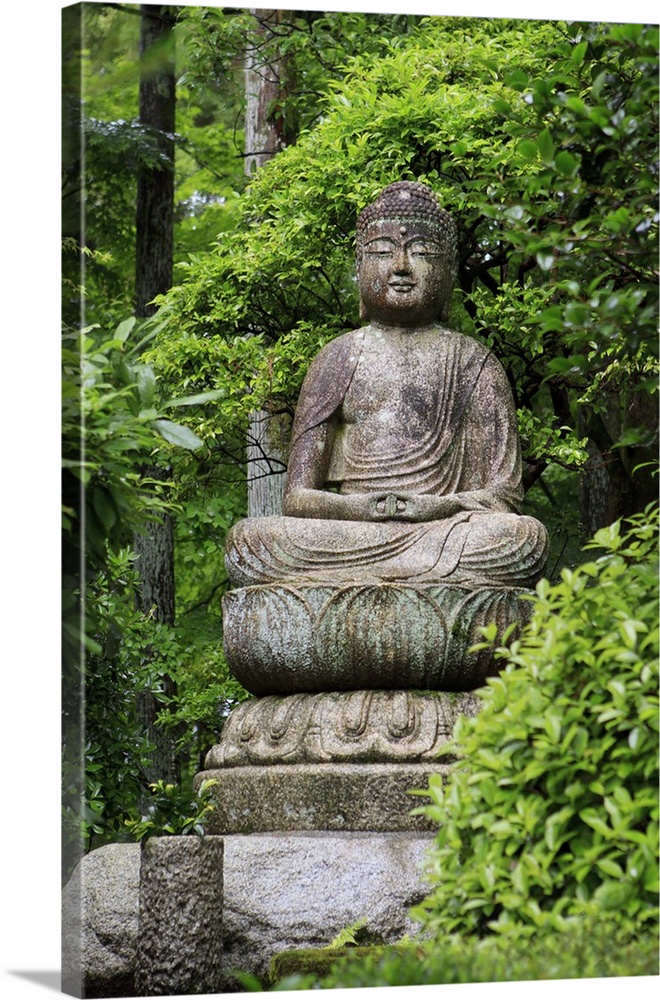 A stone Buddha statue in the grounds of Ryoan-Ji Temple, Kyoto, Japan.