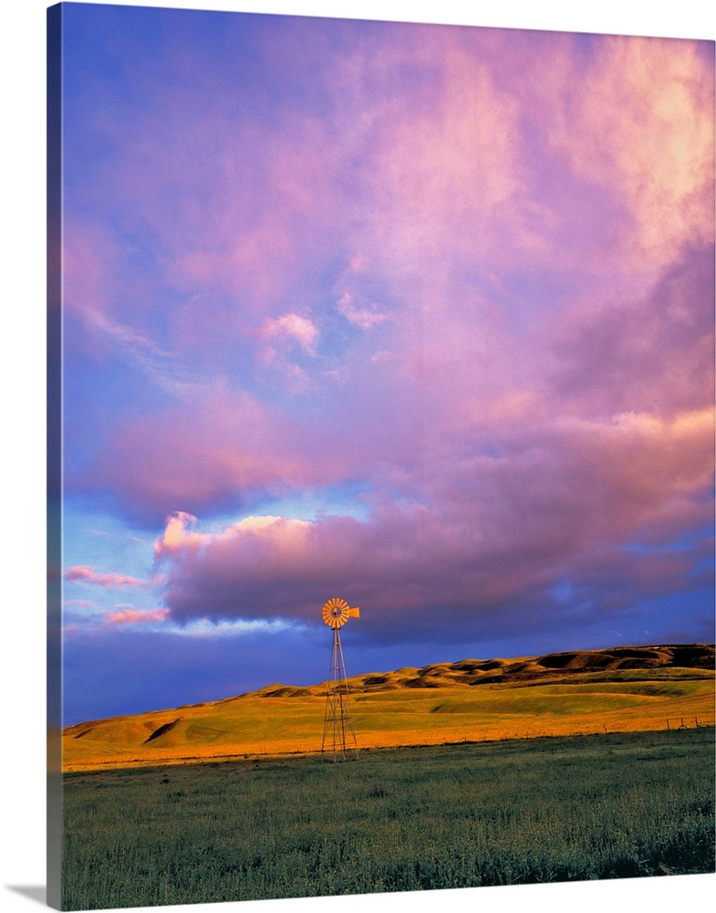 A windmill is dwarfed by enormous violet clouds in Ventura County, California.