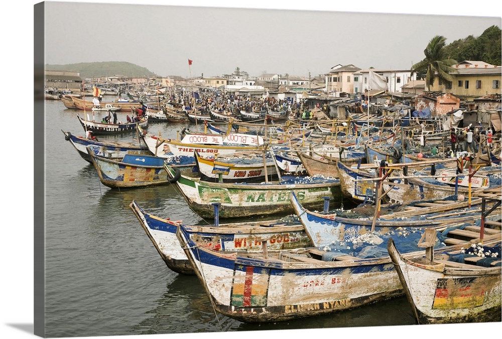 Africa, West Africa, Ghana, Elmina. Colorful hand-painted fishing boats tied up at Elmina port.