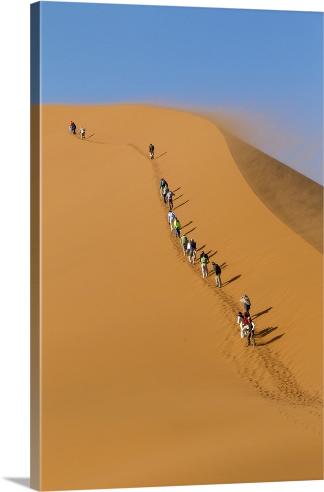 Africa, Namibia, Namib Desert, Namib-Naukluft National Park, Sossusvlei, Dune 45.  Tourists beginning the climb up Dune 45...
