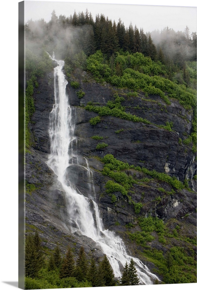 USA, Alaska, Prince William Sound, waterfall in rainforest along Harriman Fiord on rainy summer afternoon.