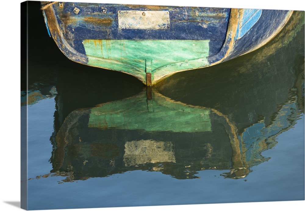 Africa, Morocco, Essouira. An artistic watercolor effect of a wooden boat floating in the harbor.