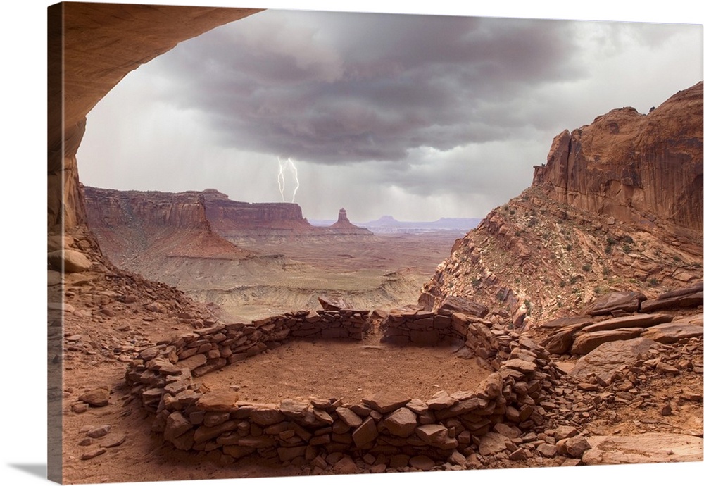 USA, Utah, Canyonlands National Park. View of Anasazi ruin with thundercloud and lightning in background.