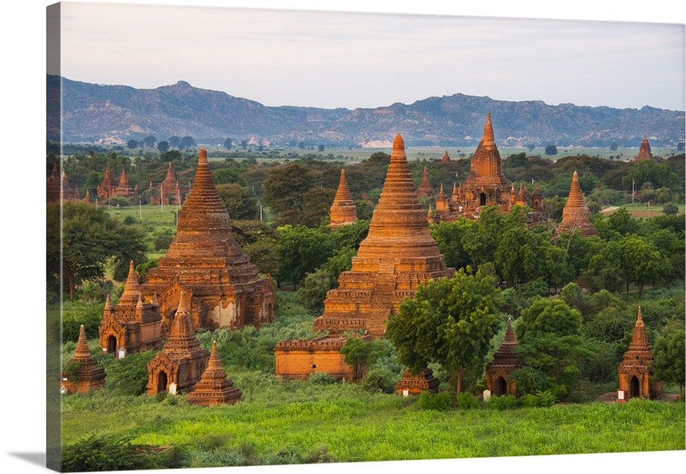 Ancient temple and pagoda rising out of the jungle at sunrise, Bagan, Mandalay Region, Myanmar.