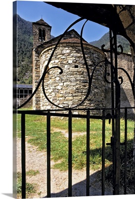 Andorra, A wrought-iron gate frames a circular stone building in Andorra