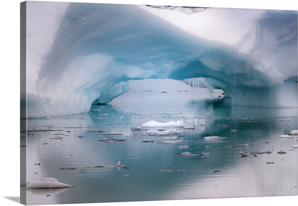 Antarctica. Artistic open arch in an iceberg.