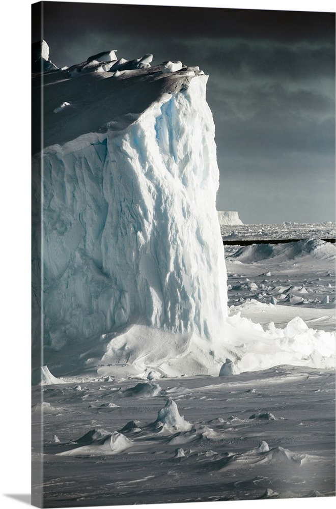 Antarctica. Iceberg at sunrise surrounded by sea ice.