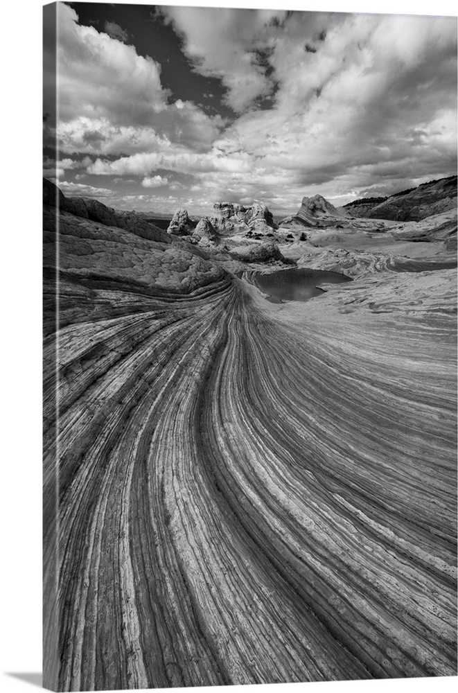North America, USA, Arizona. Black and white image of clouds, a small pool, and the geological formations found at Vermill...
